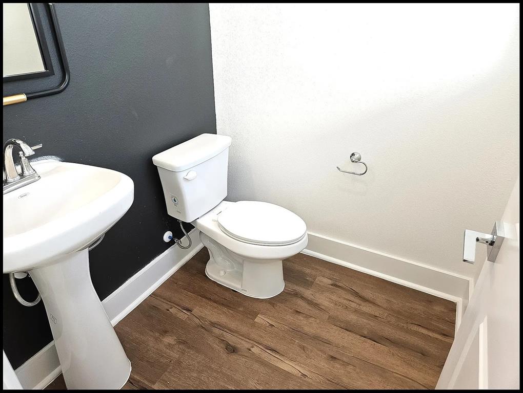 13325 Bee Street, Unit 406 Farmers Branch, TX 75234 - Photo 21 of 30 Bathroom featuring dark wood-style floors and a textured wall