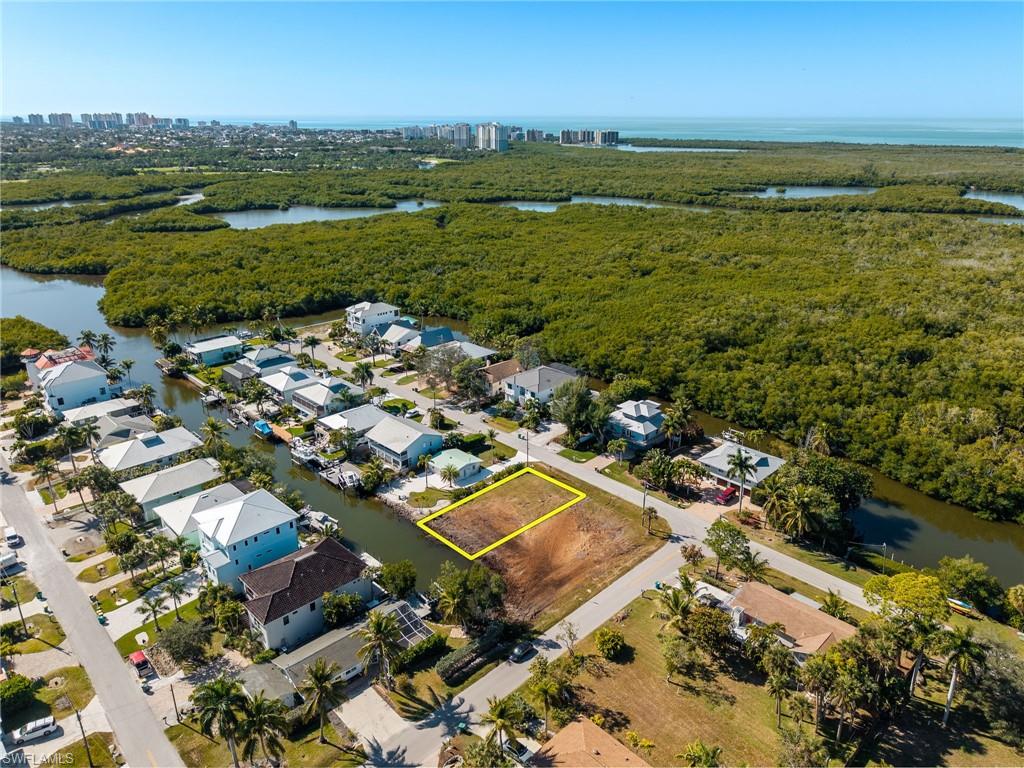 1292 Venetian Way Naples, FL 34110 - Photo 13 of 35 an aerial view of a city with lots of residential buildings ocean and mountain view in back