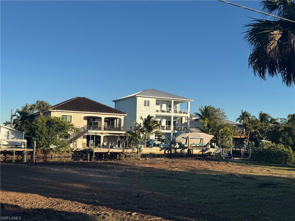 1292 Venetian Way Naples, FL 34110 - Photo 8 of 35 a front view of a house with garden
