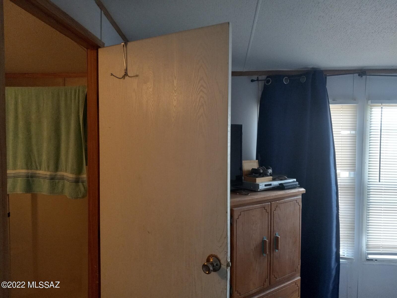 1453 North Taylor Road Willcox, AZ 85643 - Photo 12 of 31 a bathroom with a sink a mirror and shower