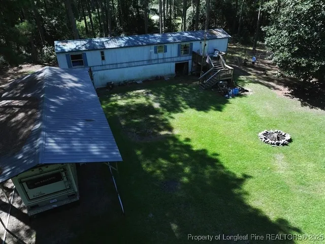 a backyard of a house with yard and outdoor seating