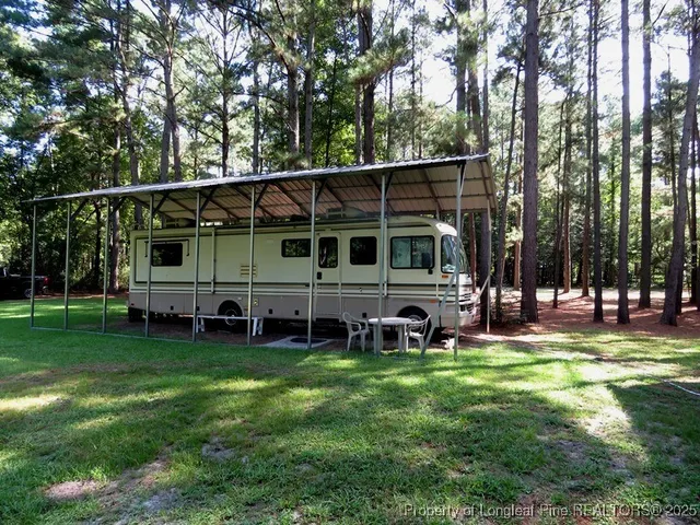 a view of a house with a yard and sitting area