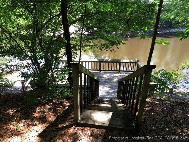 a view of balcony with wooden floor and trees