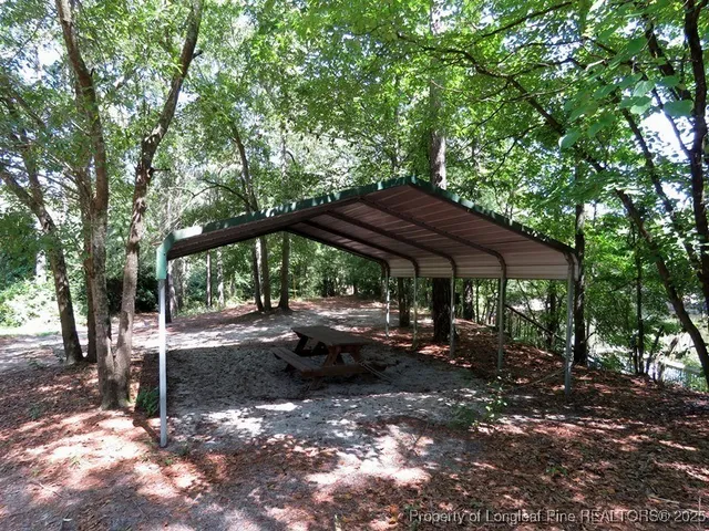 a view of patio with a table and chairs under an umbrella