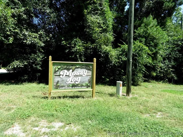 a sign that is sitting in the grass