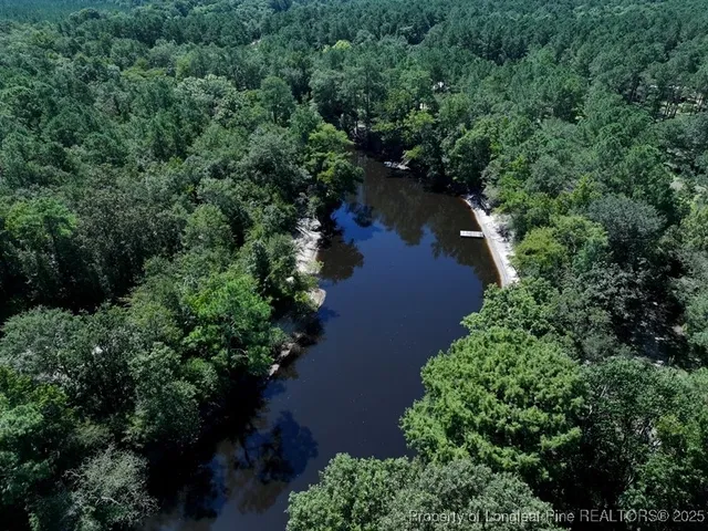 an aerial view of a houses with yard