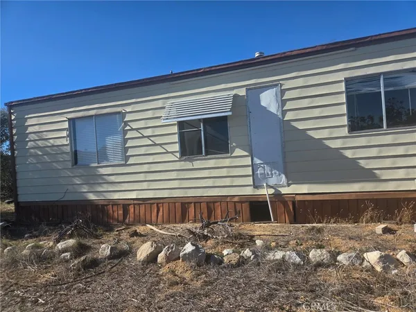 a view of a house with snow on the road