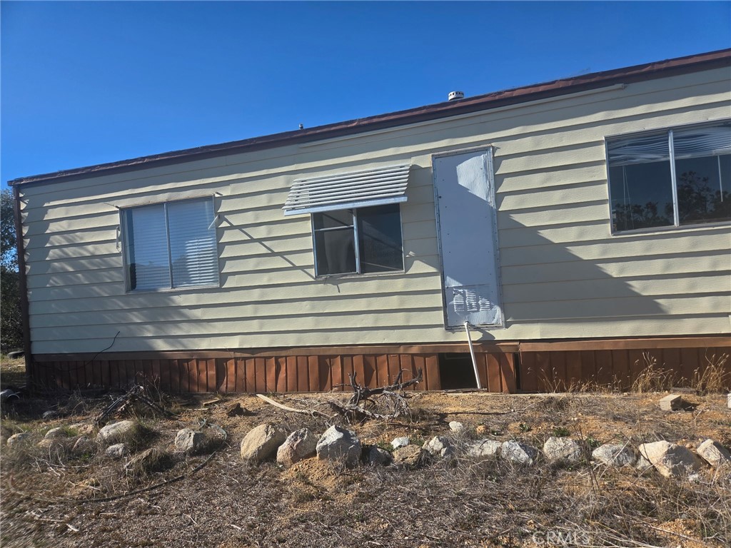 a view of a house with snow on the road