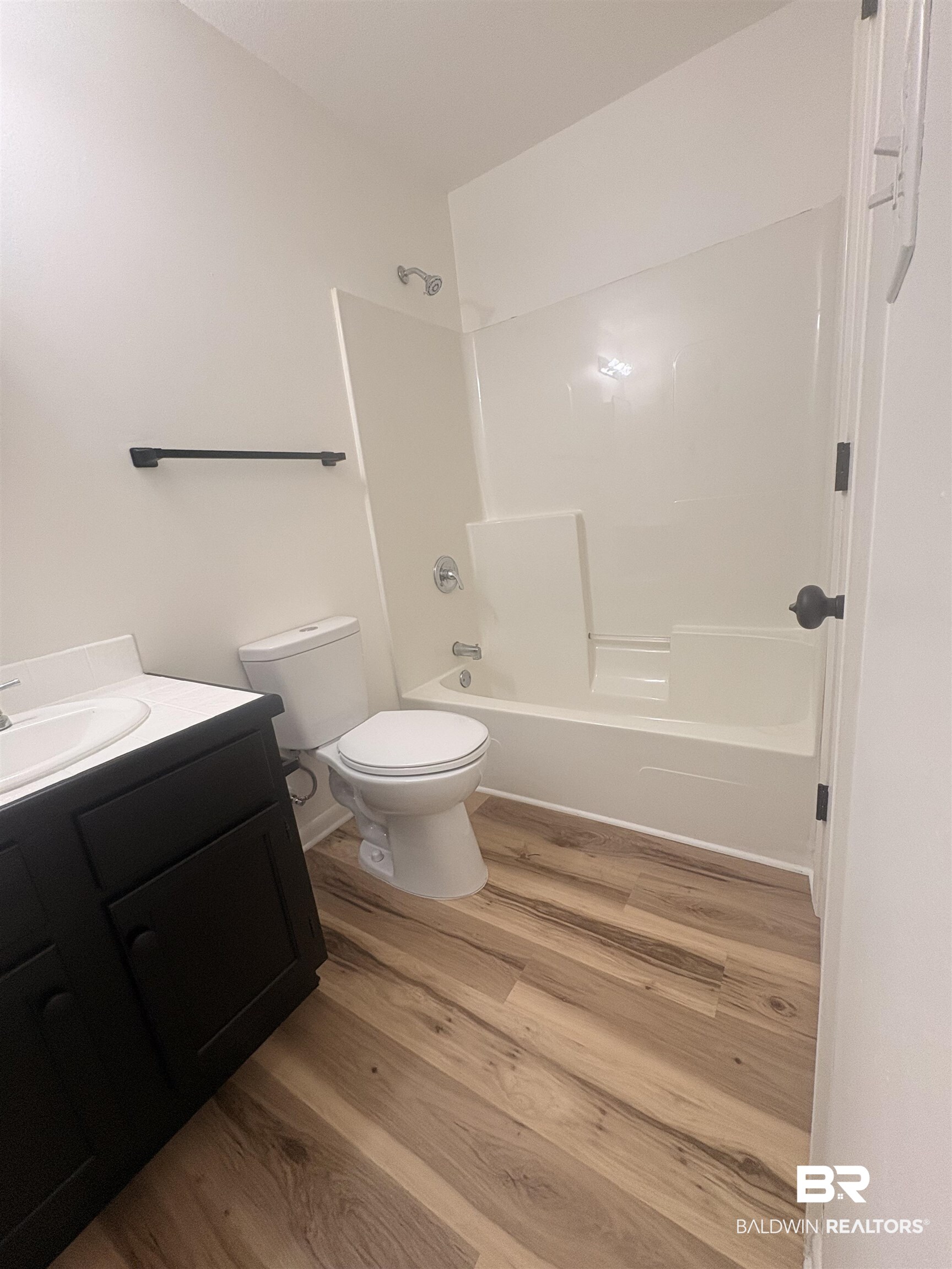 109-111 North Beech Street, Unit A & B Foley, AL 36535 - Photo 9 of 16 Bathroom featuring vanity, washtub / shower combination, and light wood-style floors