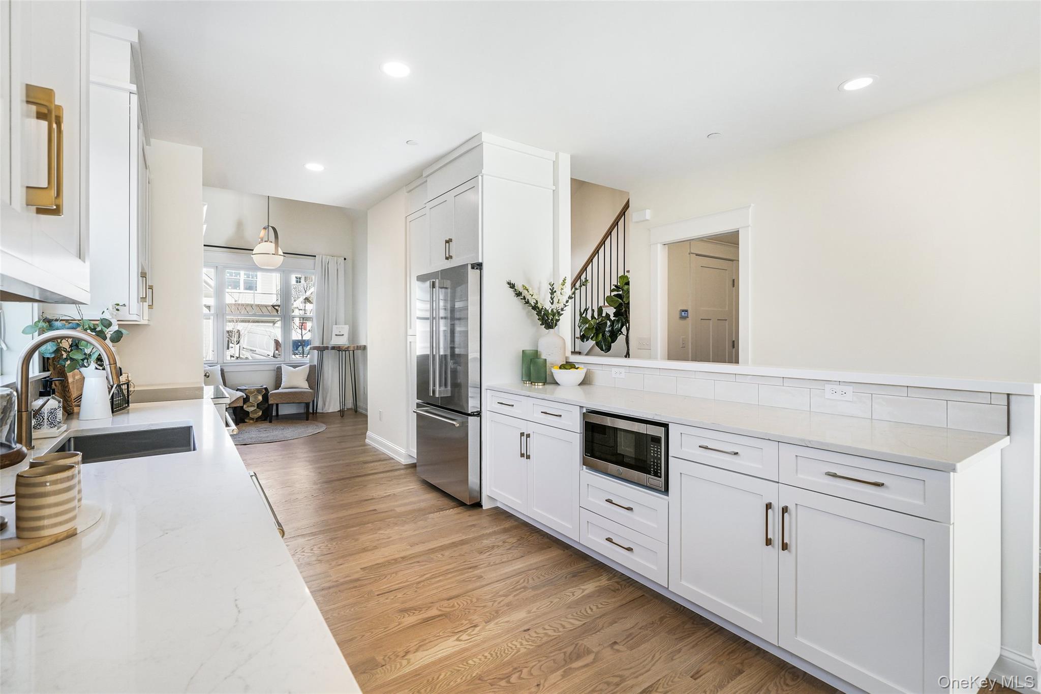 2040 Crompond Road, Unit 12 Yorktown Heights, NY 10598 - Photo 4 of 29 a kitchen with stainless steel appliances white cabinets and wooden floors