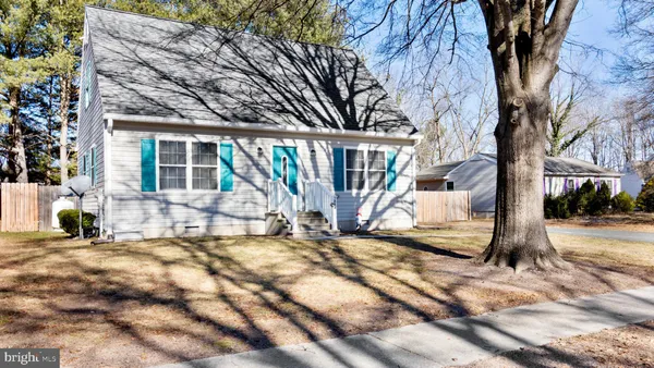 a view of a house with a tree in the background