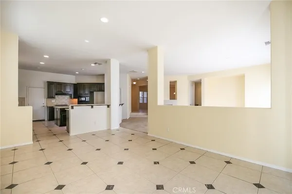a view of kitchen with furniture and refrigerator