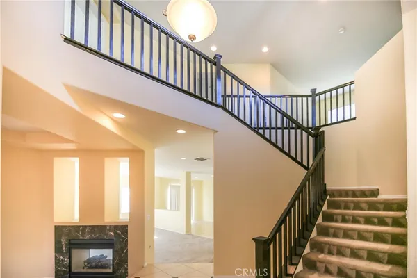 a view of staircase with railing and a window