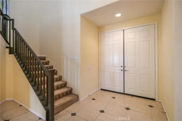 a view of a hallway with wooden floor and entryway