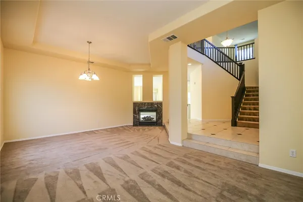 a view of a livingroom with wooden floor and stairs