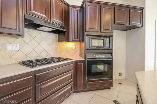 a kitchen with granite countertop a stove and a microwave oven