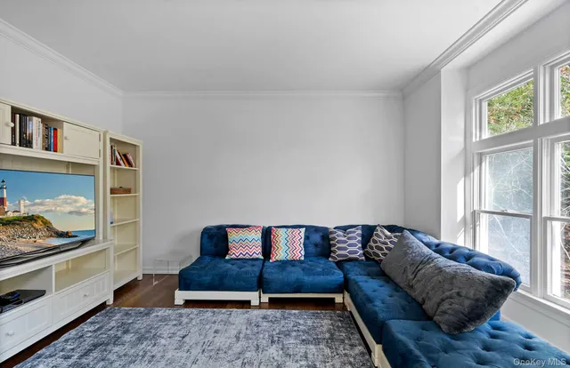 a living room with a couch and a book shelf