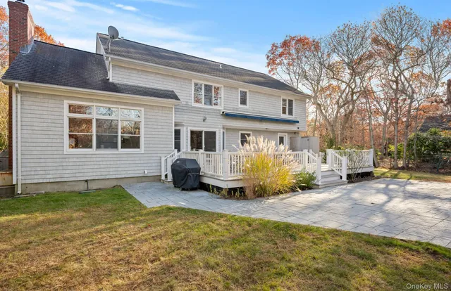 a view of a house with a large tree in front of it