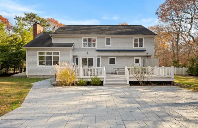 a front view of a house with a garden and sitting area