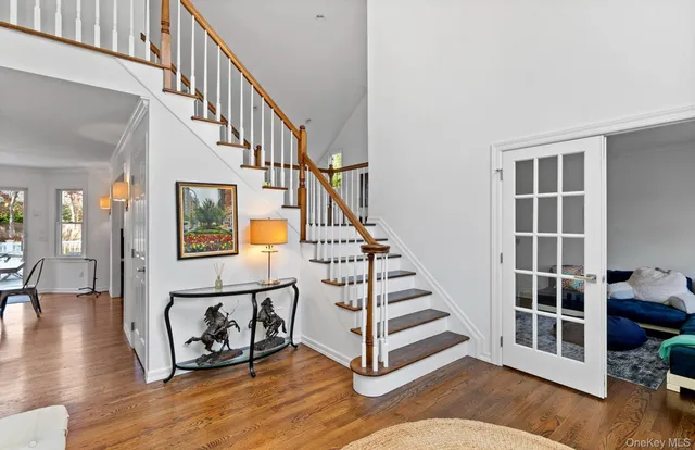 a view of entryway and hall with wooden floor