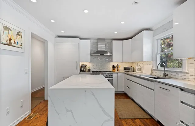 a kitchen with a sink window and cabinets