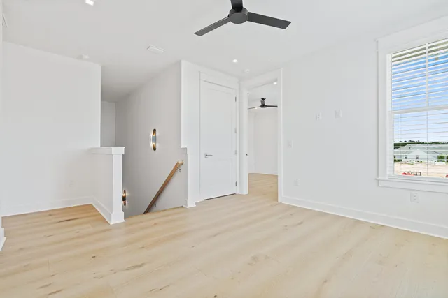 a living room with furniture a fireplace and a floor to ceiling window