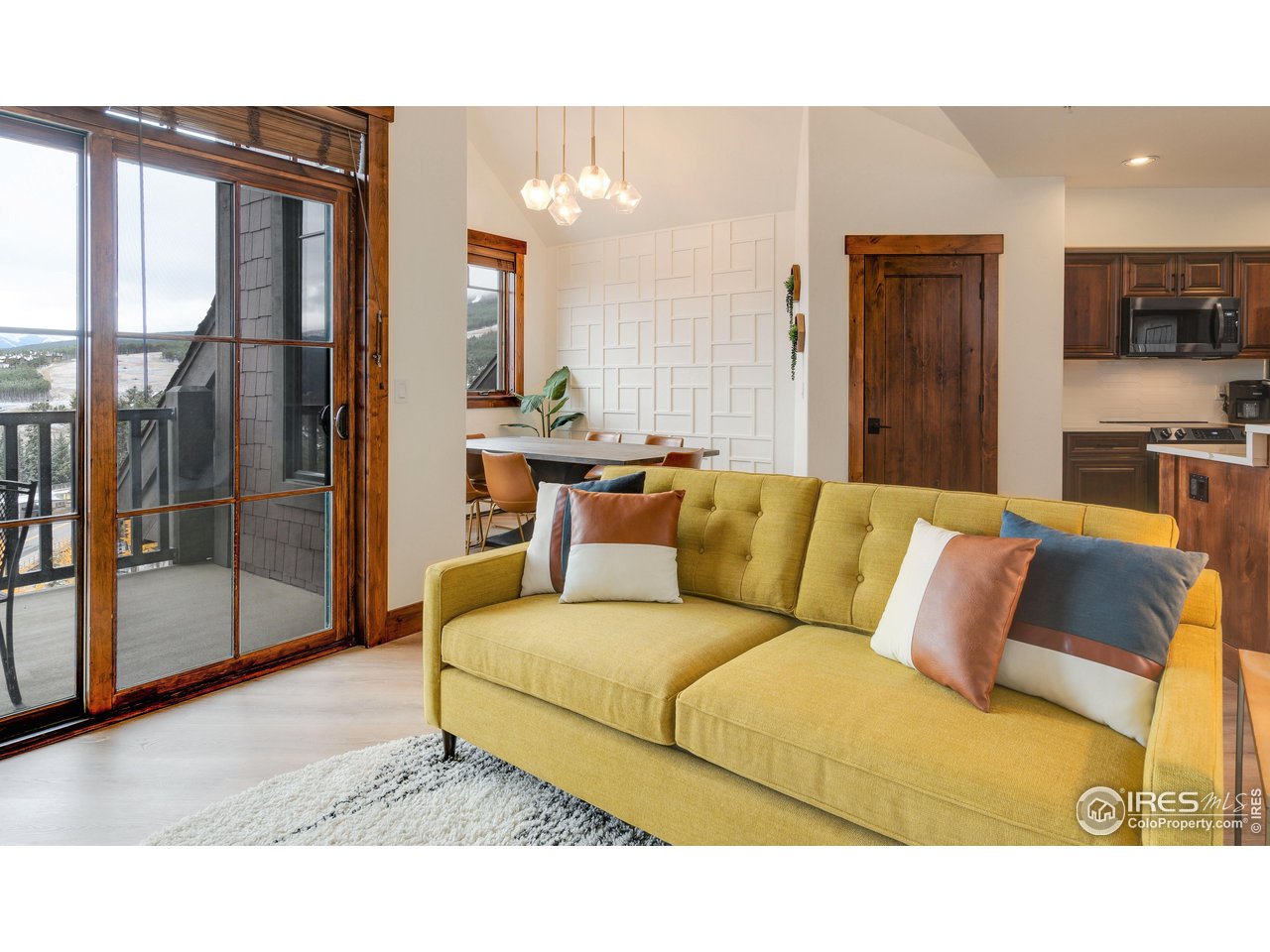 a living room with furniture and a floor to ceiling window