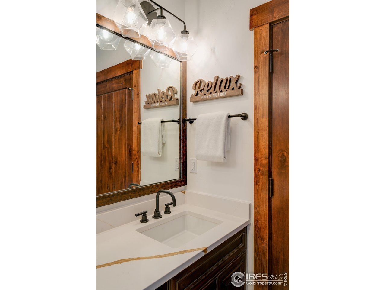 1891 Ski Hill Road, Unit 7408 Breckenridge, CO 80424 - Photo 12 of 30 a bathroom with a sink and a mirror