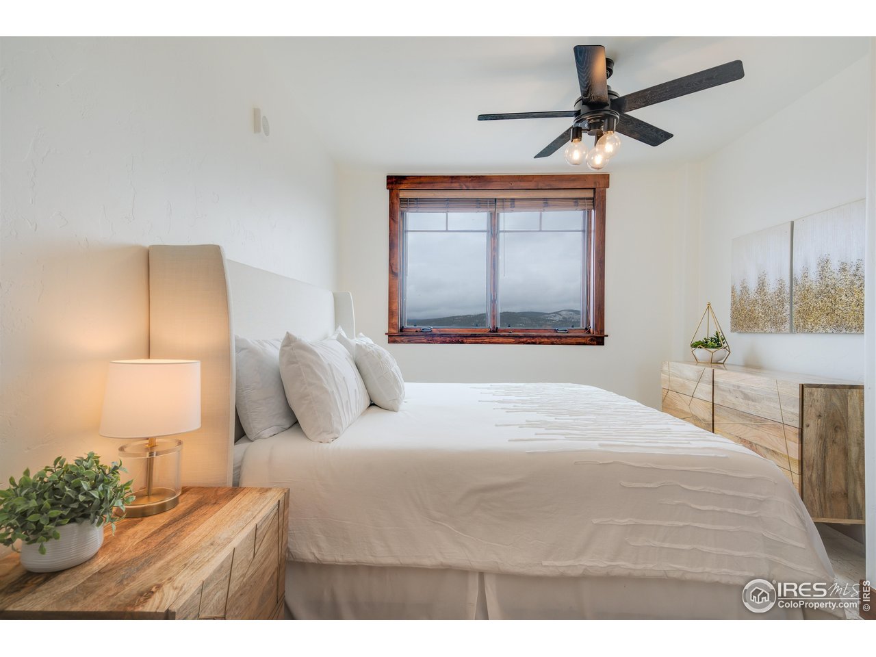 1891 Ski Hill Road, Unit 7408 Breckenridge, CO 80424 - Photo 13 of 30 a bedroom with a bed and a painting on the wall