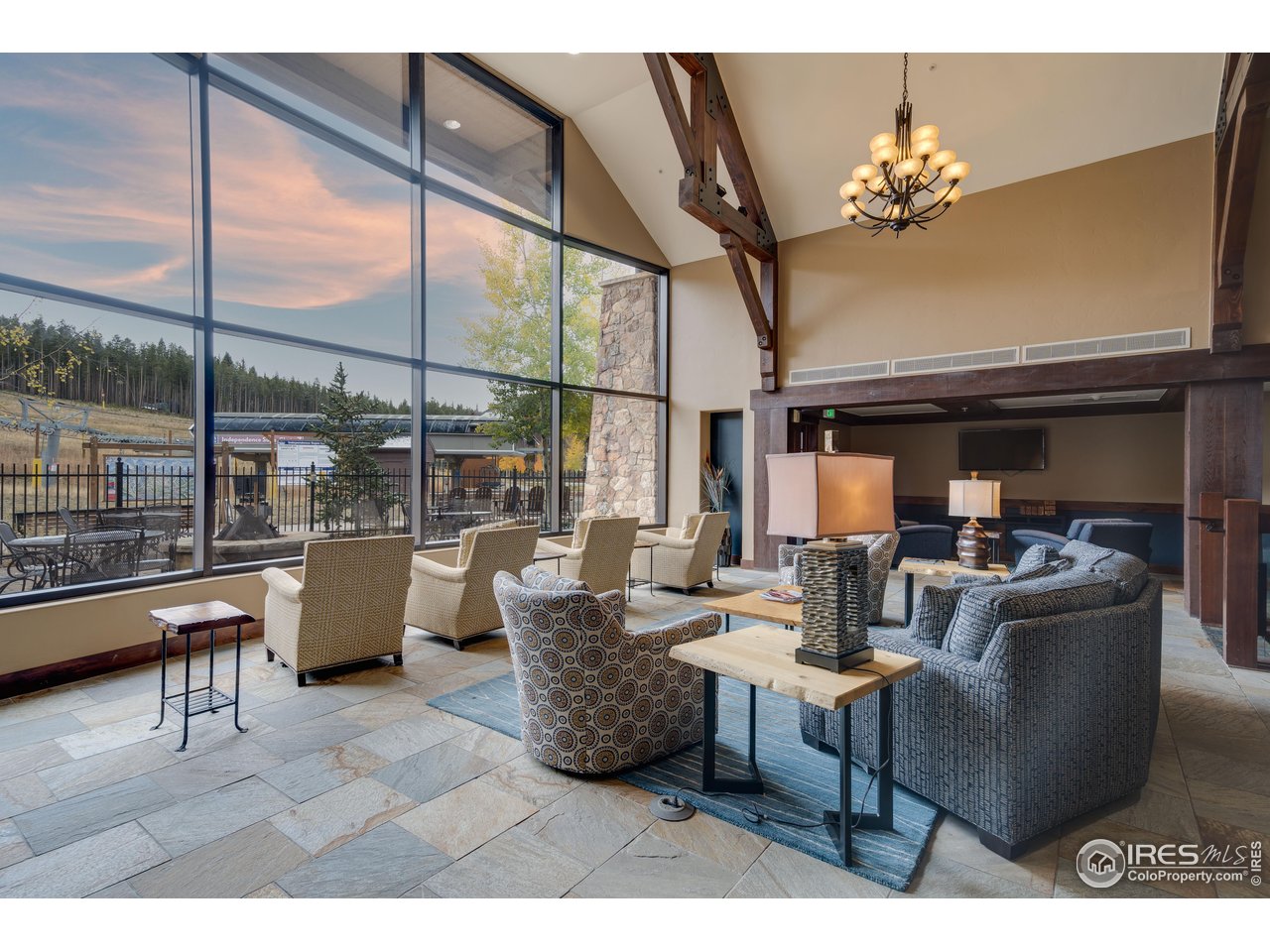 1891 Ski Hill Road, Unit 7408 Breckenridge, CO 80424 - Photo 24 of 30 a living room with patio furniture and a chandelier