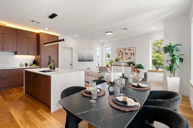 a kitchen with a table chairs stove and kitchen view