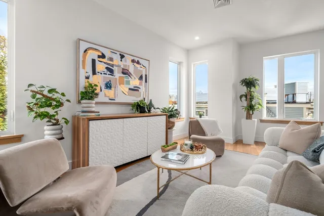 a living room with furniture and a potted plant