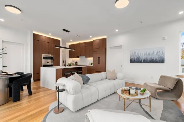 a living room with furniture and kitchen view