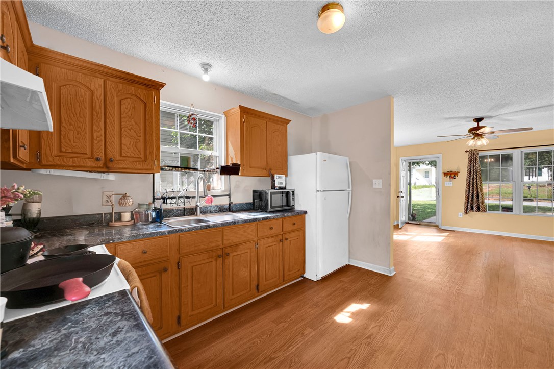 1020 Elizabeth Street Anderson, SC 29624 - Photo 12 of 22 A well-equipped kitchen features ample cabinetry and a window over the sink, seamlessly flowing into a sun-drenched living space.