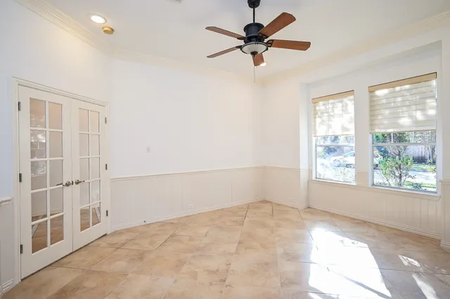 a view of an empty room with kitchen and fireplace