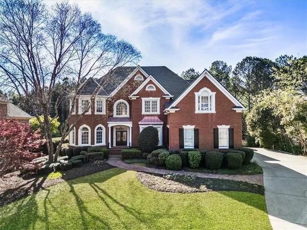 a front view of a house with swimming pool and porch