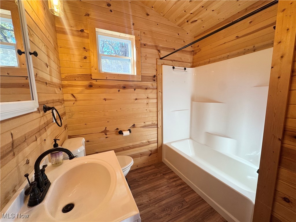 11376 Trinity Church Road Lisbon, OH 44432 - Photo 10 of 18 Bathroom with wood walls, dark wood-style floors, vanity, vaulted ceiling, and wood ceiling