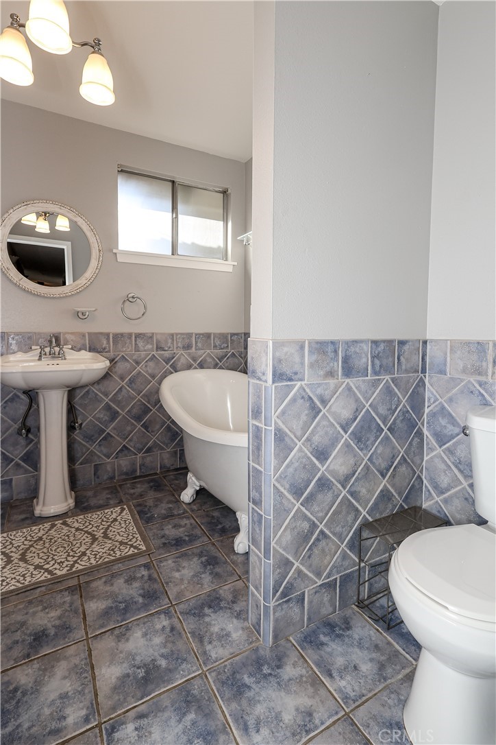 2121 Teak Avenue Merced, CA 95340 - Photo 24 of 40 a bathroom with a sink a toilet and a mirror