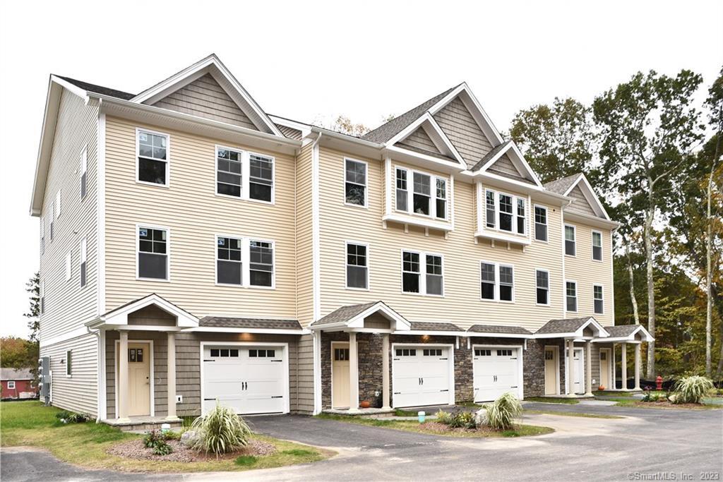 46 Village Crossing, Unit 46 Niantic, CT 06357 - Photo 1 of 24 a front view of a large white building