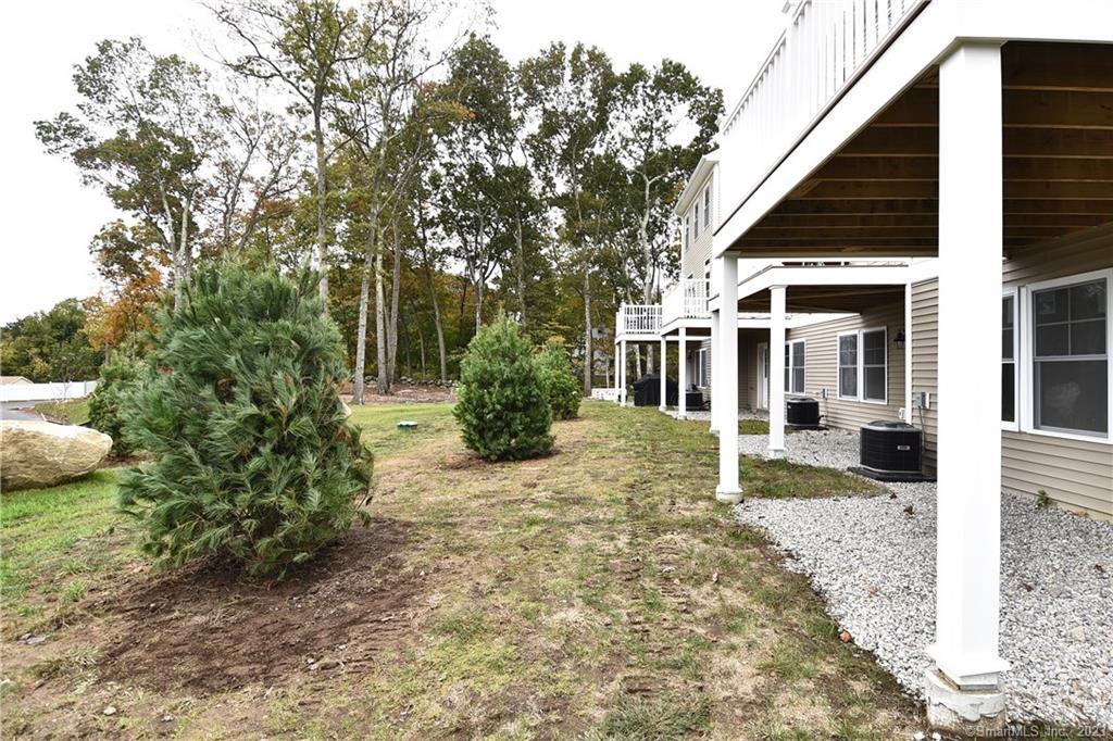 46 Village Crossing, Unit 46 Niantic, CT 06357 - Photo 23 of 24 a front view of a house with a garden and plants