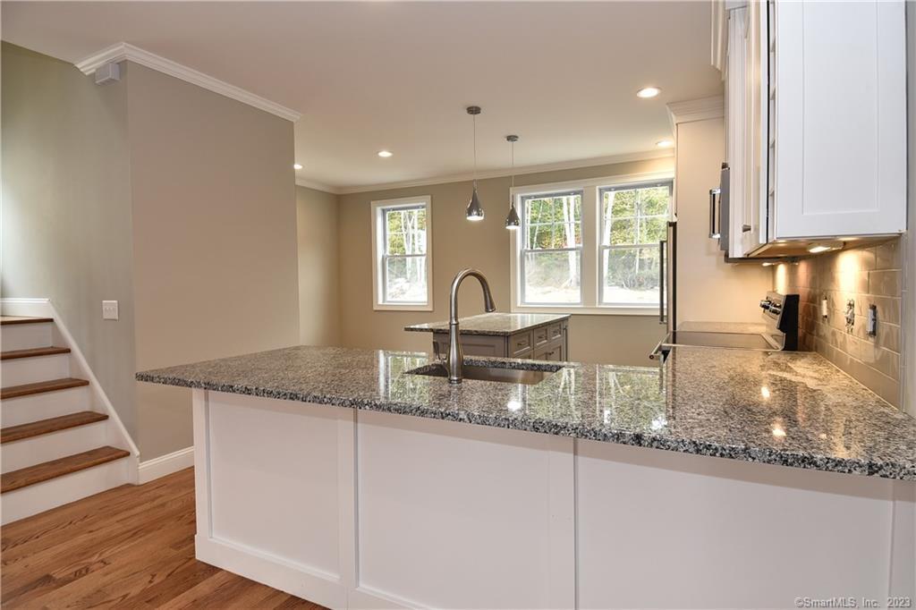 46 Village Crossing, Unit 46 Niantic, CT 06357 - Photo 4 of 24 a kitchen with granite countertop a sink and a window