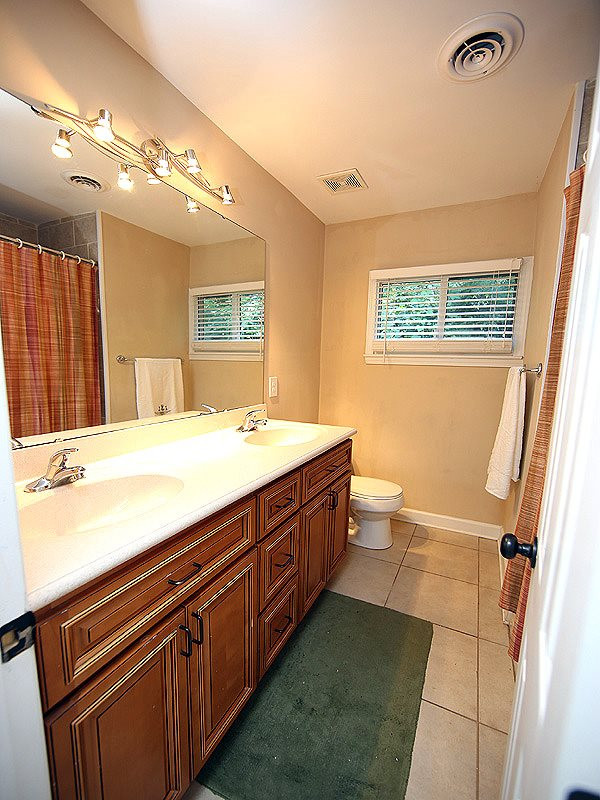 1315 Chaney Road Raleigh, NC 27606 - Photo 20 of 25 Fully updated with dual sink, beautiful cabinetry and tile floor. Hall Bath
