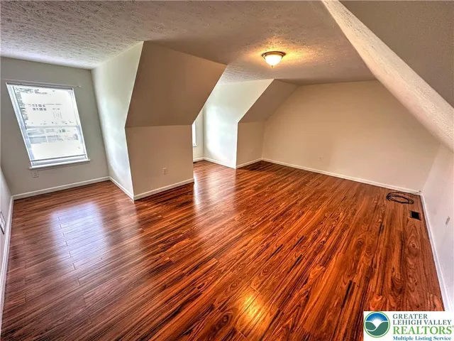 a kitchen with granite countertop a sink a stove a microwave and cabinets