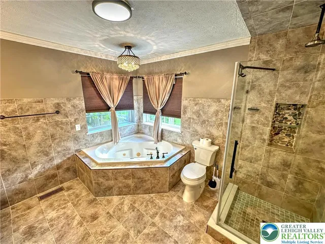 a kitchen with stainless steel appliances granite countertop a refrigerator stove and wooden floor