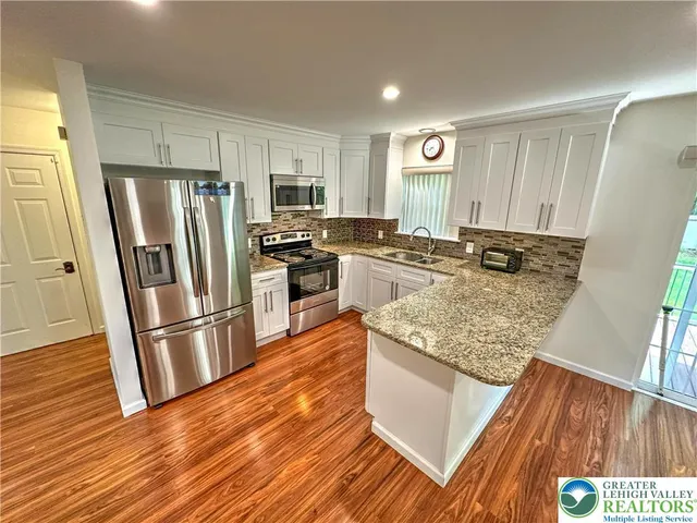 a bathroom with a double vanity sink toilet and a mirror