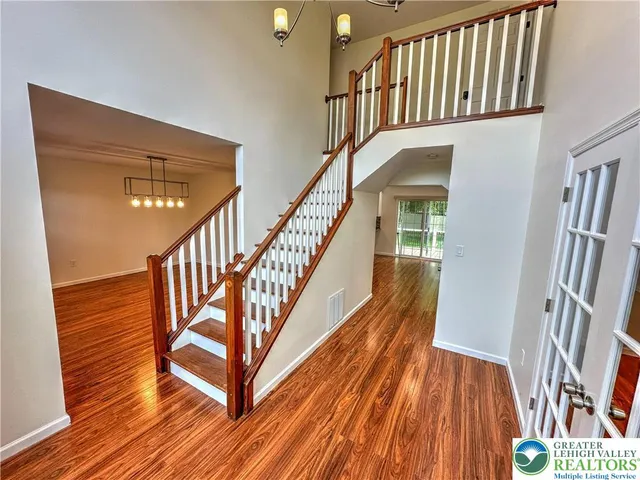 a view of staircase with wooden floor and a rug