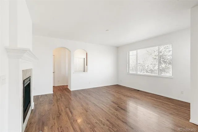 wooden floor in an empty room with a window