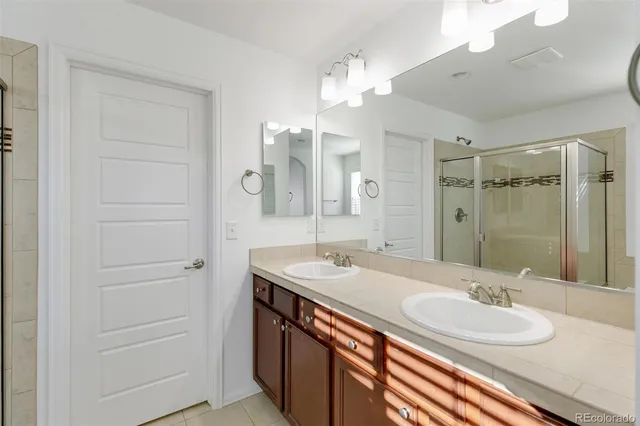 a bathroom with a sink double vanity and a mirror
