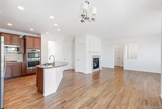 a kitchen with stainless steel appliances a white stove top oven and cabinets