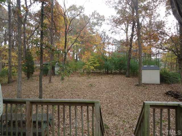 7628 Mine Valley Road Raleigh, NC 27615 - Photo 8 of 8 a backyard of a house with lots of green space